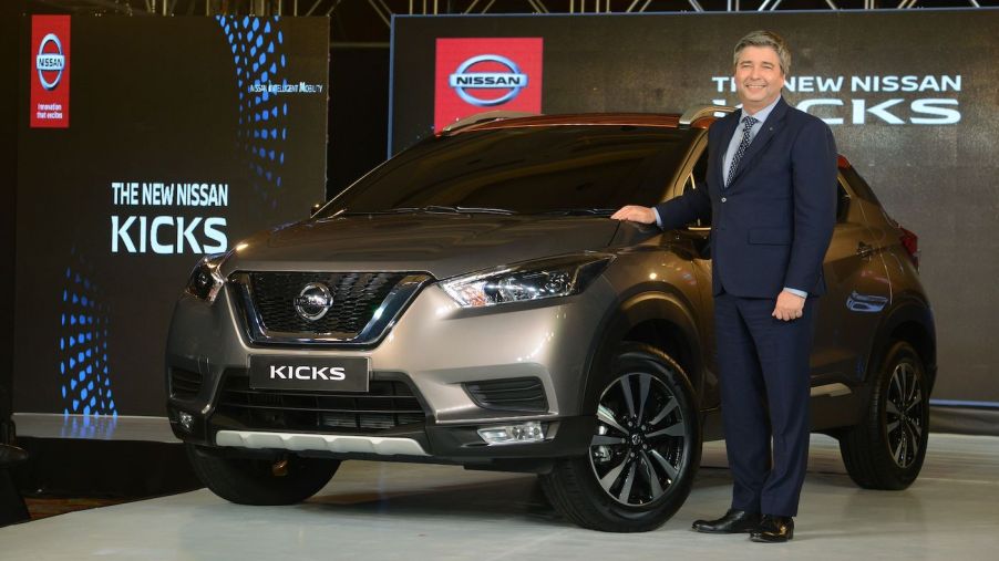 Nissan India's president Thomas Kuehl poses with the new compact SUV 'Kicks' during its launch in Mumbai