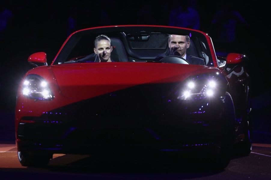 Karolina Pliskova of Czech Republic and Oliver Blume, CEO of Porsche AG, drive on the court with the winner's car Porsche 718 Boxster GTS after Pliskova won the singles final match
