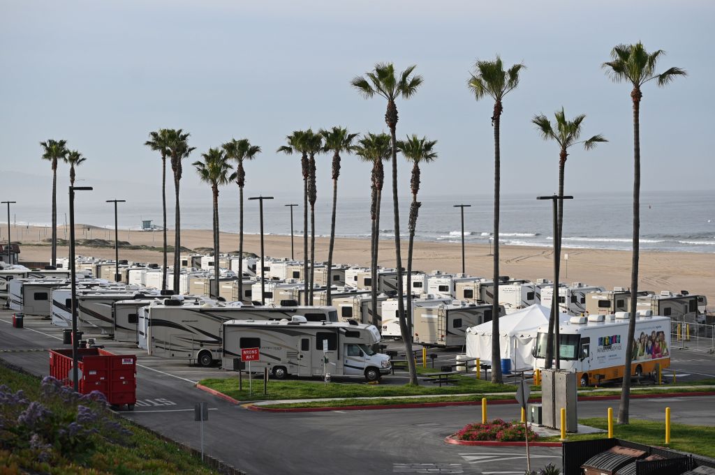 Campers parked in a lot next to the beach
