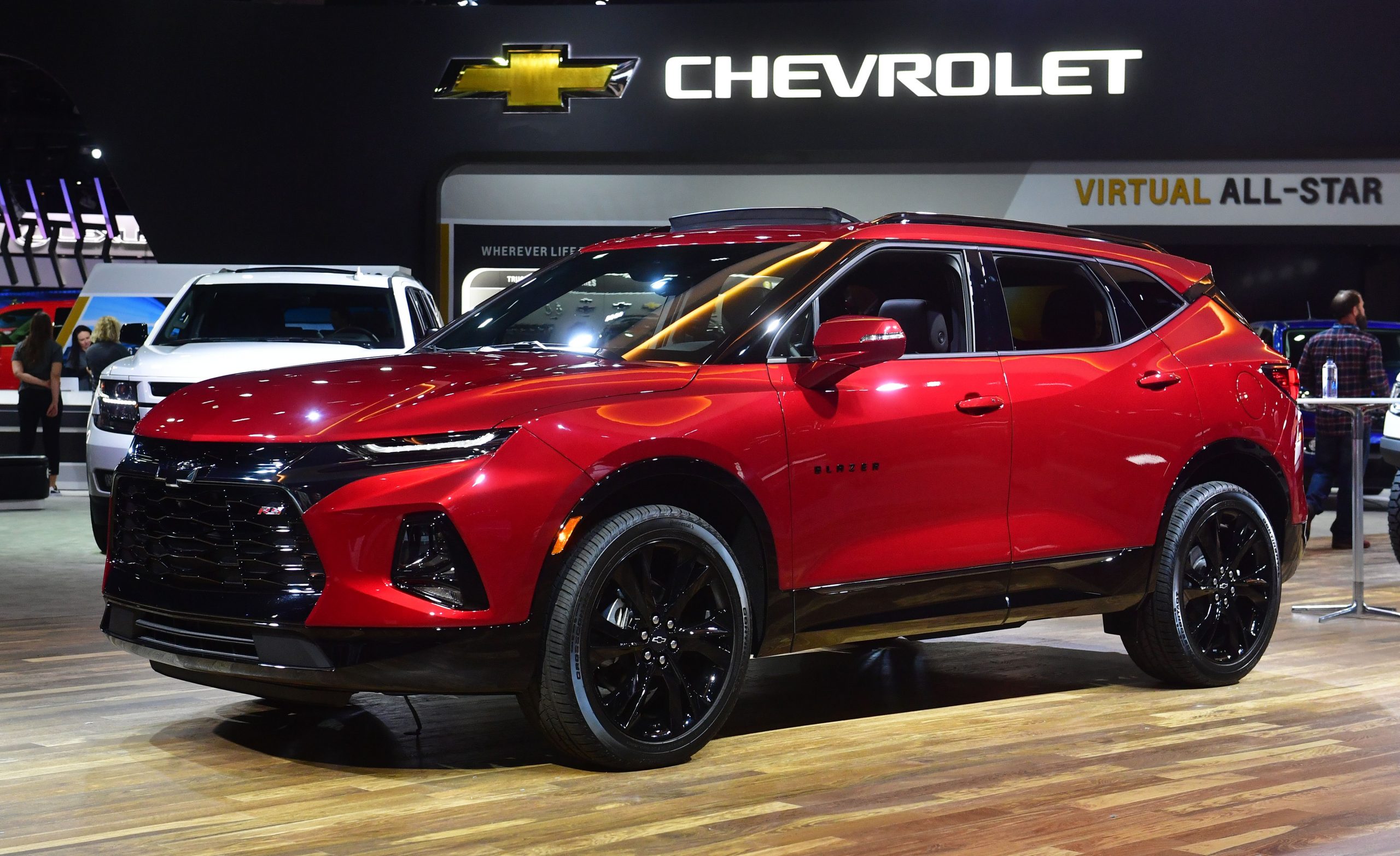 a red Chevy Blazer on display at an auto show