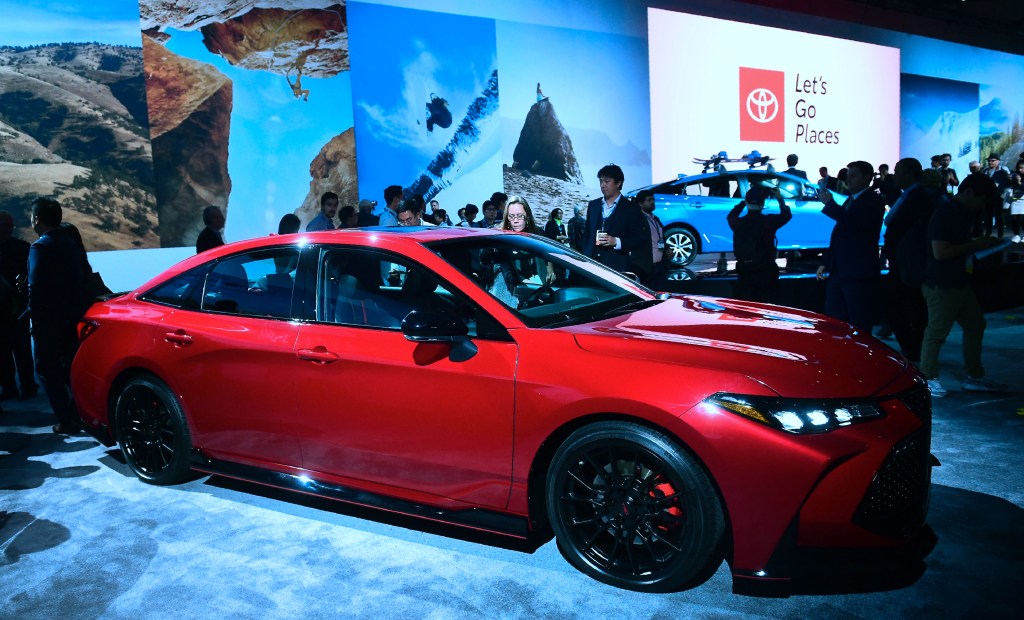 A red Toyota Avalon at an auto show