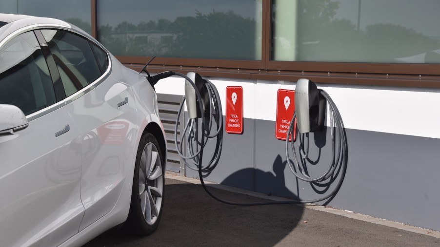 A Tesla Model 3 is charged at the charging station for TESLA electric vehicles, manufacturer of electric vehicles