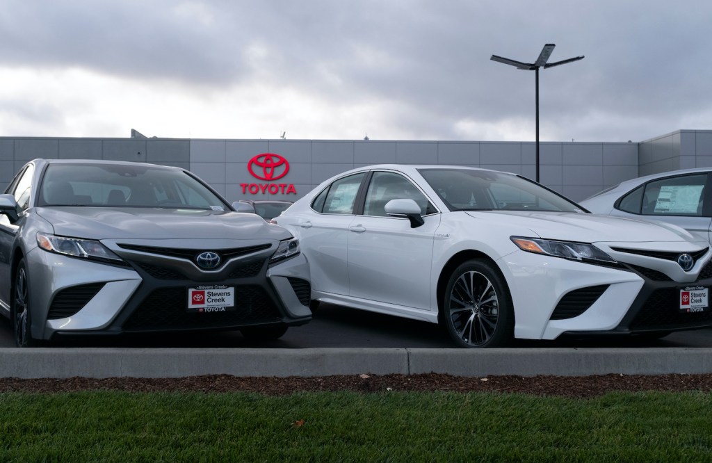 A lineup of Toyota Camry models at a dealership