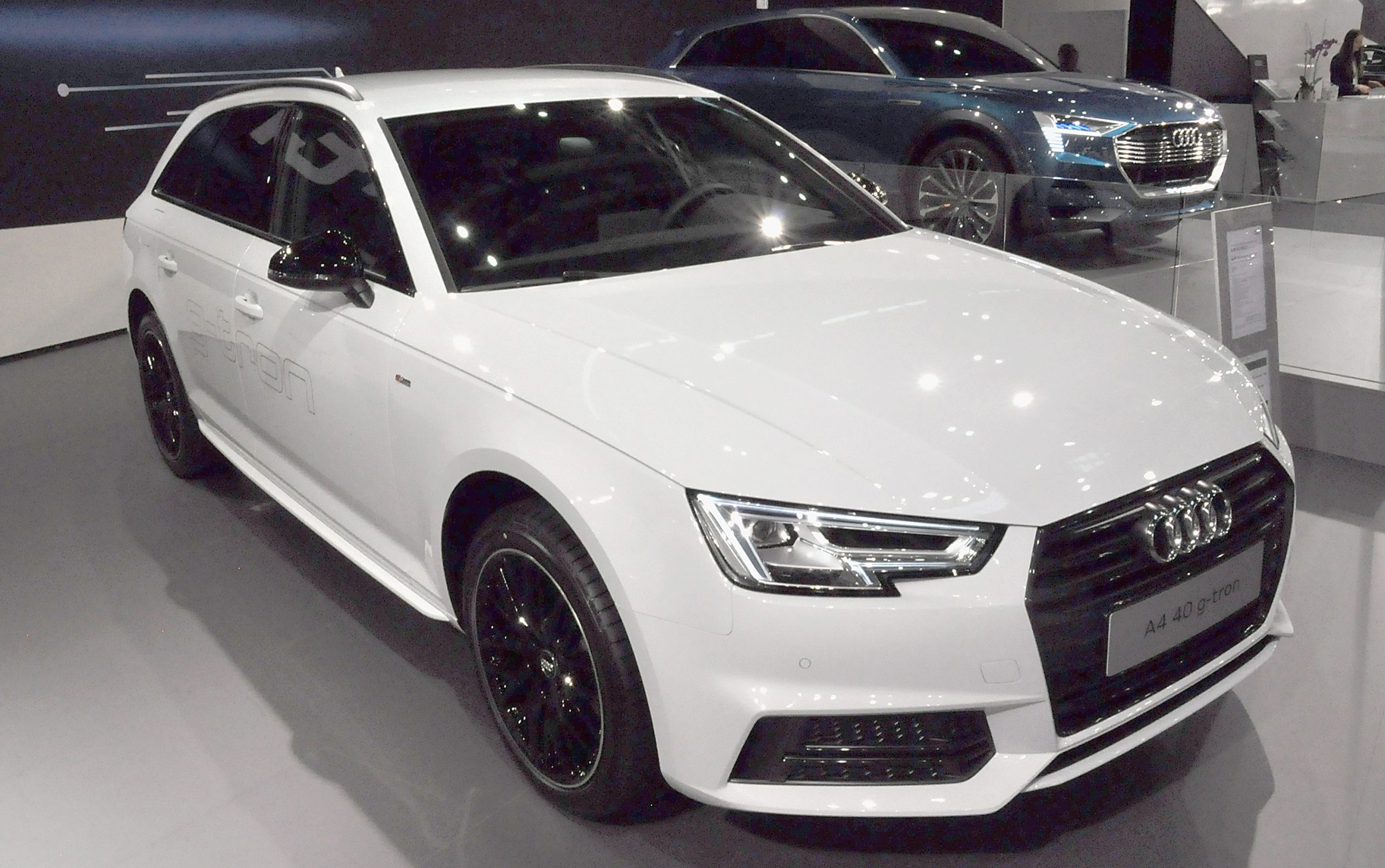 A white Audi A4 on display at an auto show