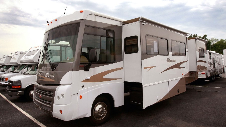 A Winnebago Sightseer motorhome is offered for sale at the Camp-Land RV dealership, which also sells travel trailers