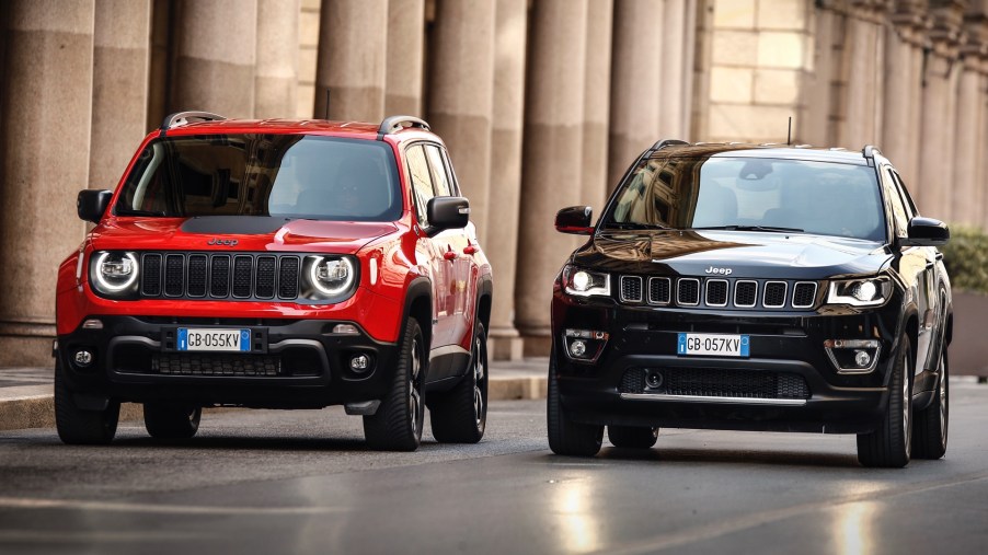 A Jeep Renegade 4xe and Jeep Compass 4xe parked on the street