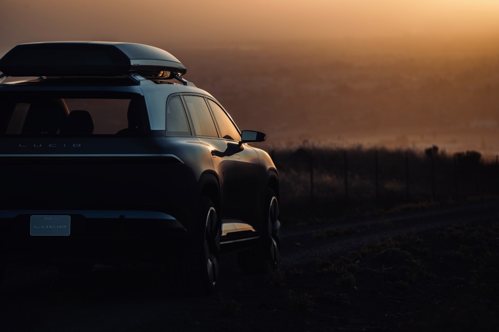 The Lucid SUV, revealed to be called the Lucid Gravity, parked while basking in the sunset
