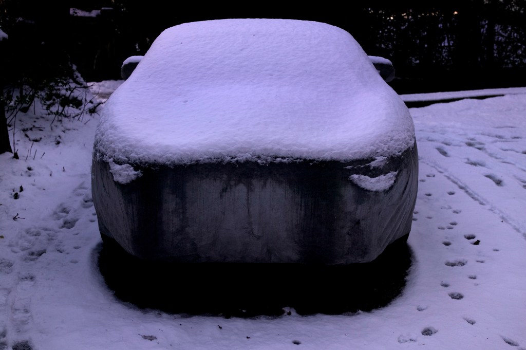 covered snowy porsche