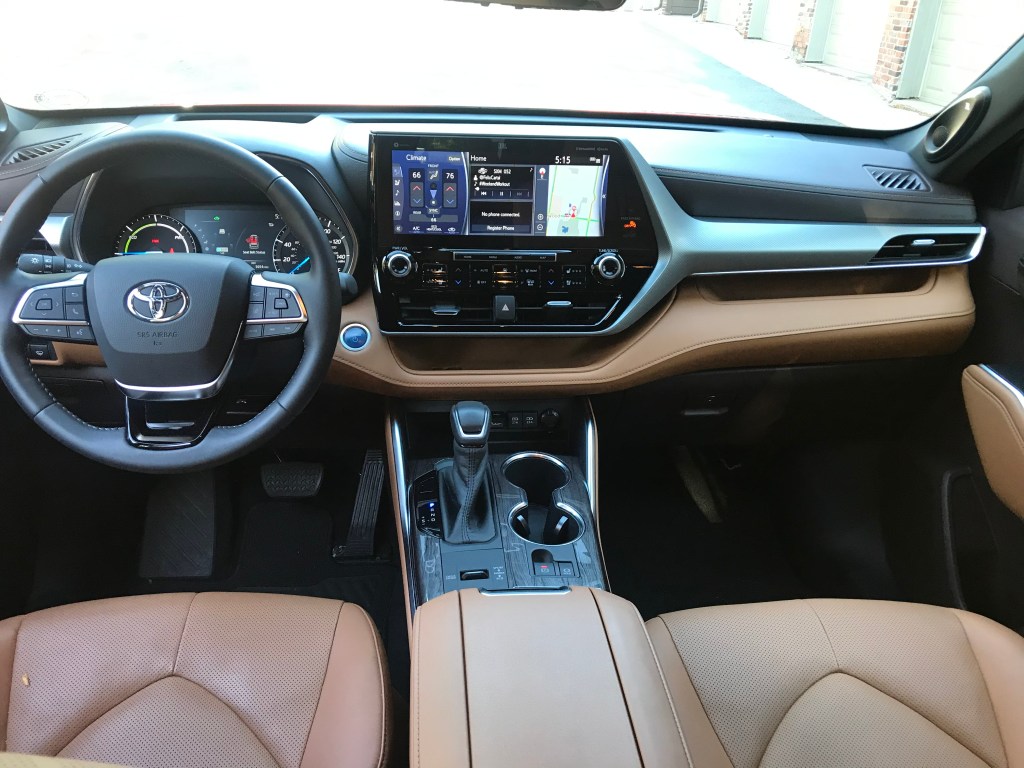 A 2020 Toyota Highlander Hybrid with brown leather seats.