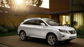 A white 2015 Lexus RX Hybrid parked in a sunny driveway.