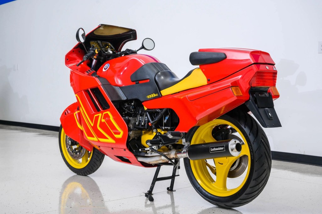 The rear 3/4 view of a red-and-yellow 1990 BMW K1