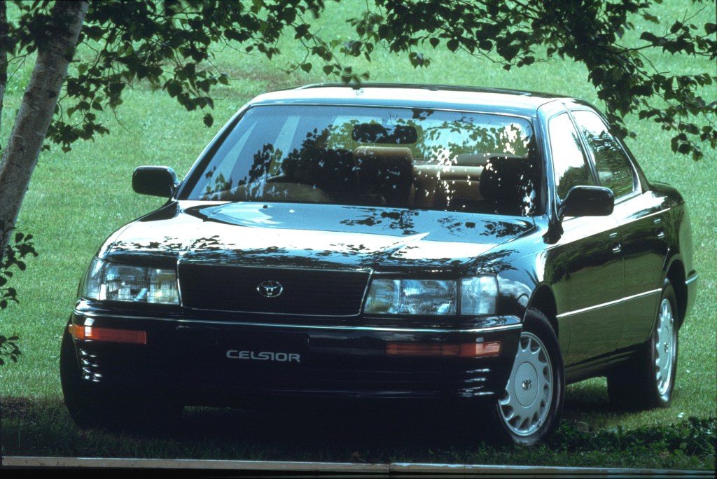 A black 1990 Toyota Celsior underneath shady trees