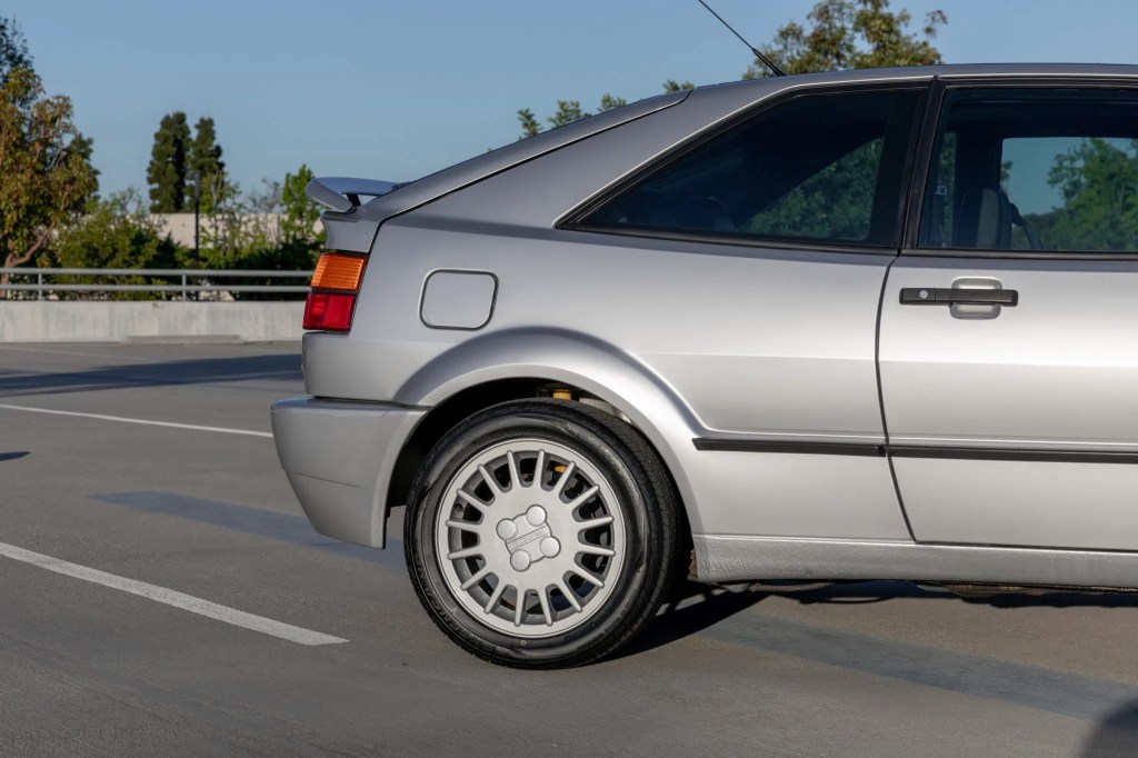 The rear half of a silver 1990 Volkswagen Corrado with its spoiler deployed