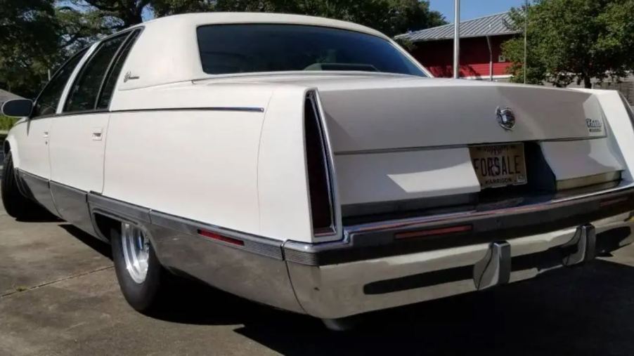 The rear of a white custom 1996 Cadillac Fleetwood Brougham