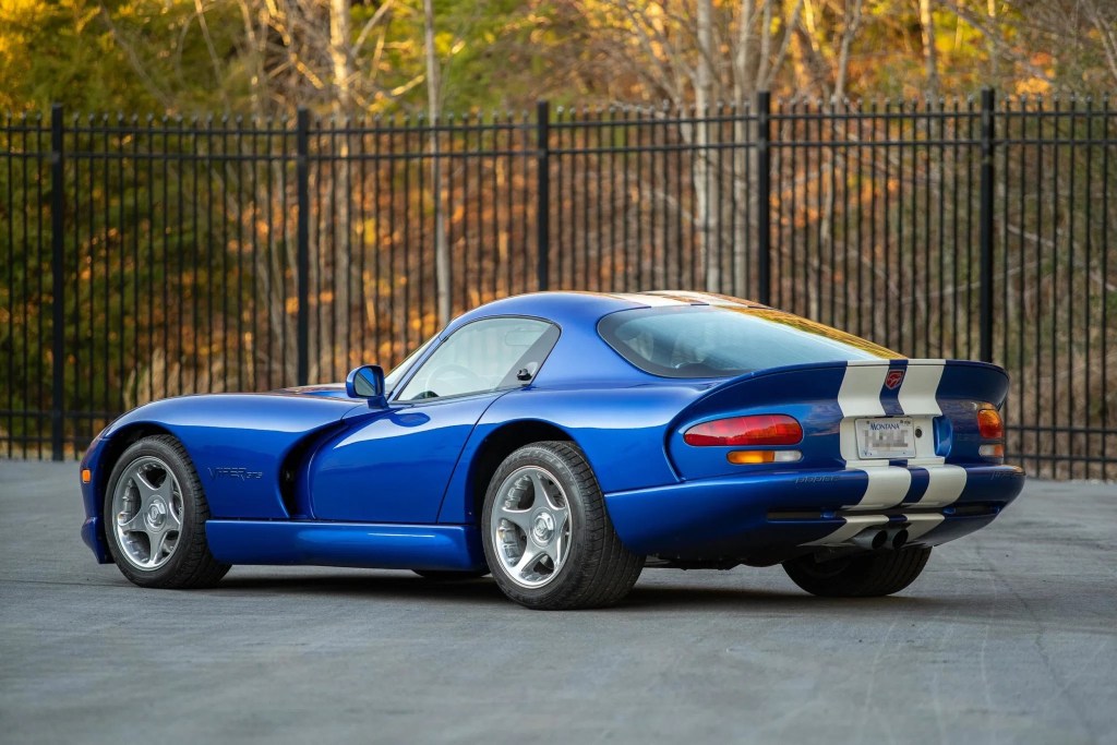 The rear 3/4 view of a blue-and-white 1996 Dodge Viper GTS coupe