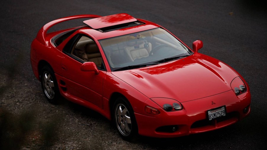 A red 1997 Mitsubishi 3000GT SL with its sunroof open