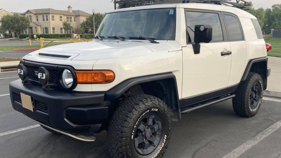 The front 3/4 view of a modified white 2008 Toyota FJ Cruiser Trails Team Edition