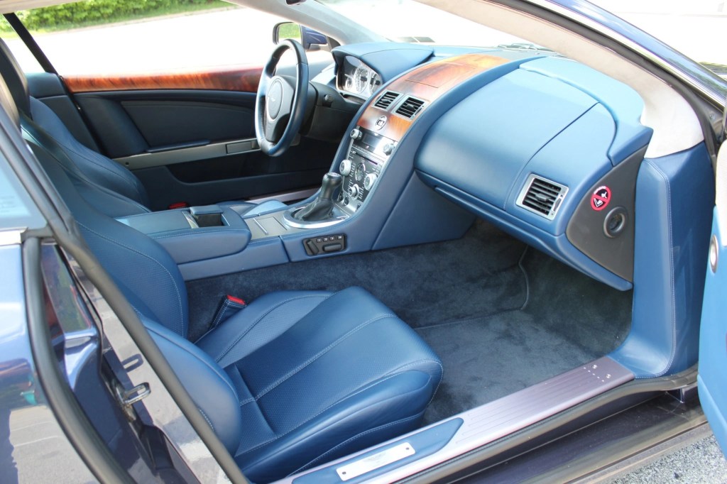 The blue-leather-upholstered interior of a manual 2009 Aston Martin DB9