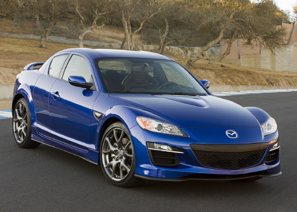 A blue 2009 Mazda RX-8 on a racetrack