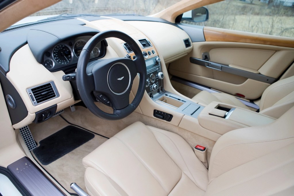 The tan-leather-upholstered interior of a 2010 Aston Martin DB9