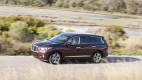 The 2014 Infiniti QX60 driving down a winding road