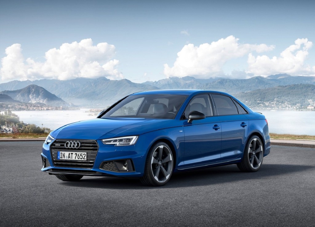 A blue 2019 Audi A4 in front of a lake