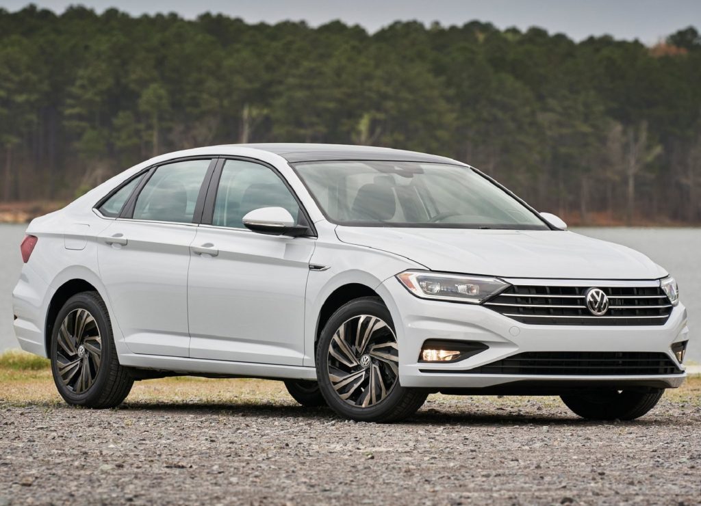 A white 2019 Volkswagen Jetta by a forest lake