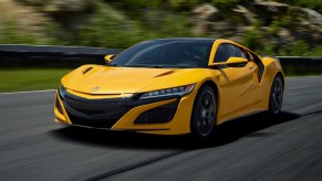 A yellow 2020 Acura NSX drives on a racetrack