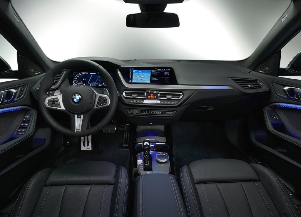 The black interior of the 2020 BMW M235i xDrive Gran Coupe with blue ambient lighting
