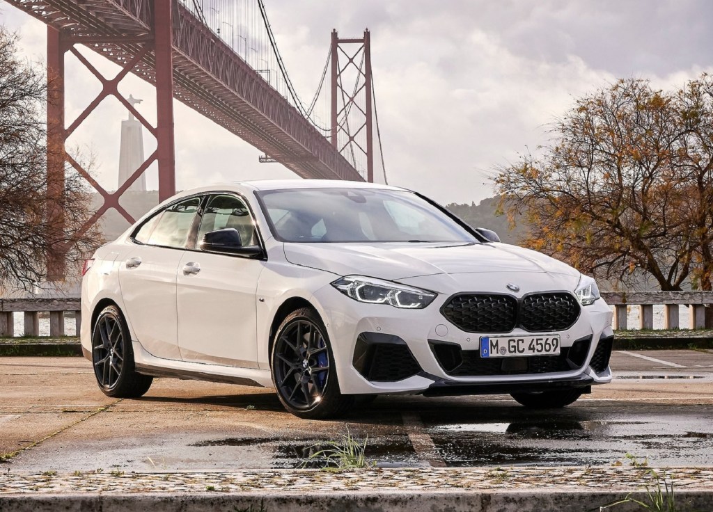 A white 2020 BMW M235i xDrive Gran Coupe in front of a bridge