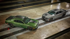 A green 2020 Dodge Challenger on display next to a silver 2020 Dodge Charger