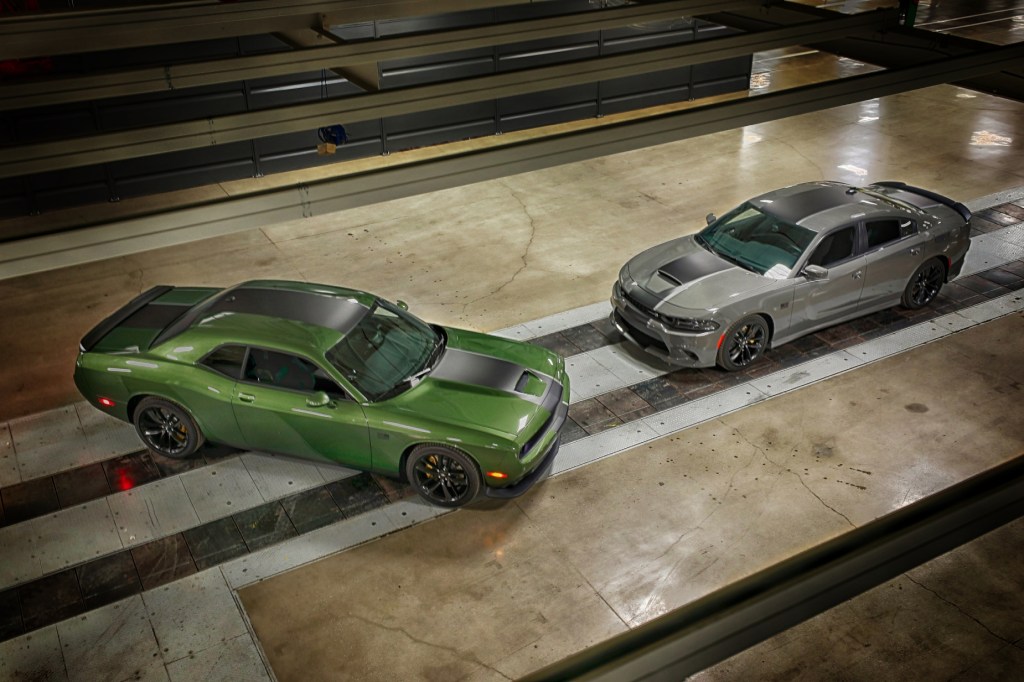 A green 2020 Dodge Challenger on display next to a silver 2020 Dodge Charger