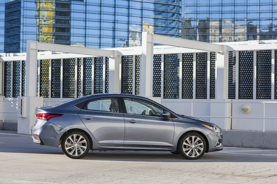 A silver 2020 Hyundai Accent parked in front of a building