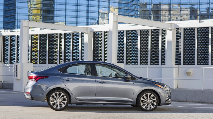 A silver 2020 Hyundai Accent parked in front of a building