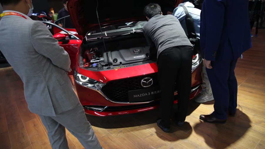 People checking out a Mazda3 at an auto show