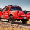 The rear view of a red 2020 Nissan Frontier modified by Nismo for the Rebelle Rally
