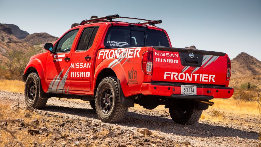 The rear view of a red 2020 Nissan Frontier modified by Nismo for the Rebelle Rally