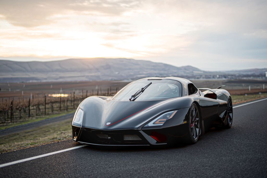 A black 2020 SSC Tuatara on a road with mountains in the background