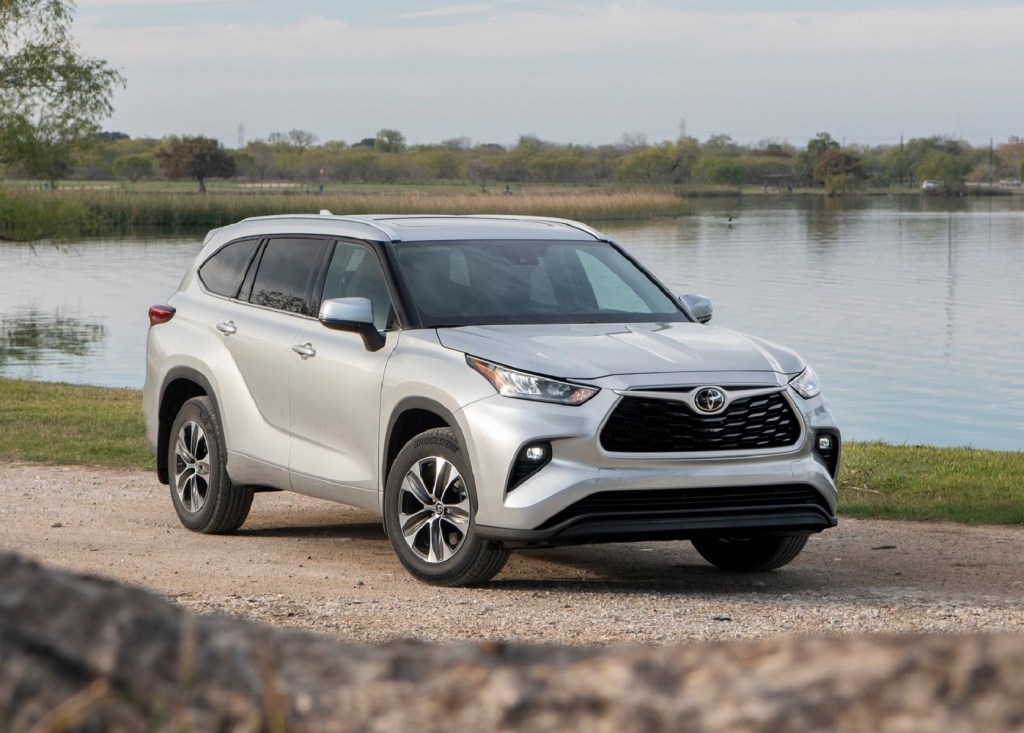 A silver 2020 Toyota Highlander by a lake