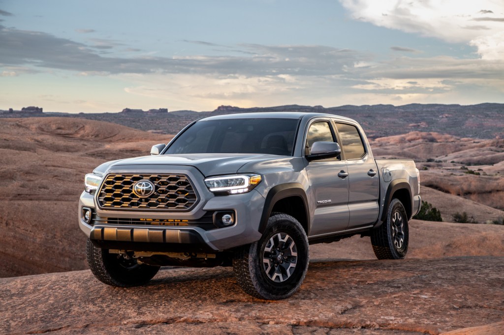 A silver 2020 Toyota Tacoma compact pickup truck, with many of the best Toyota Tacoma model years, parked on display outdoors.