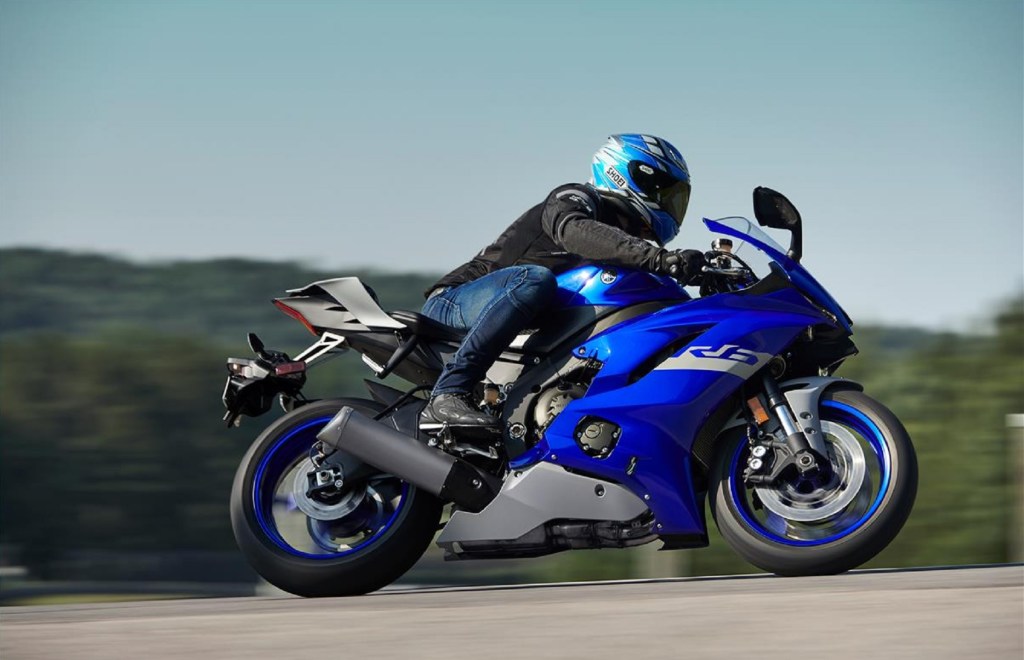 A rider takes a blue 2020 Yamaha YZF-R6 around a track