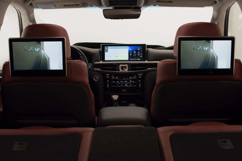 the interior of a Lexus LX 570 family SUV with entertainment screens