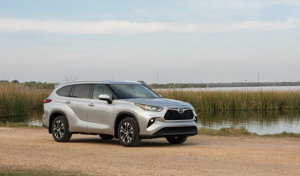 The 2020 Toyota Highlander crossover SUV, surprisingly a competitor to the Acura MDX, parked near a lake