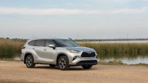 The 2020 Toyota Highlander, surprisingly a competitor to the Acura MDX, parked near a lake
