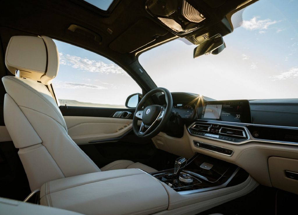 The white-leather driver's seat and white-and-black dashboard of the 2021 Alpina XB7