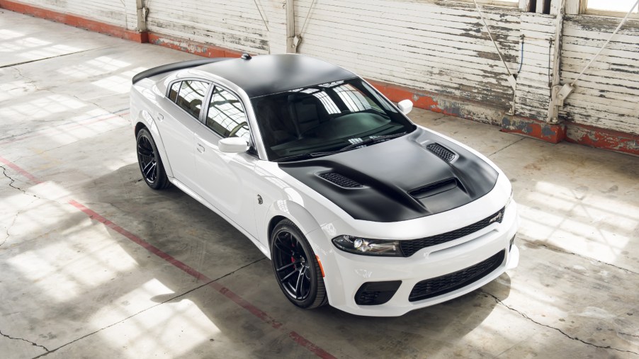 A black and white 2021 Dodge Charger Hellcat Redeye on display in a warehouse