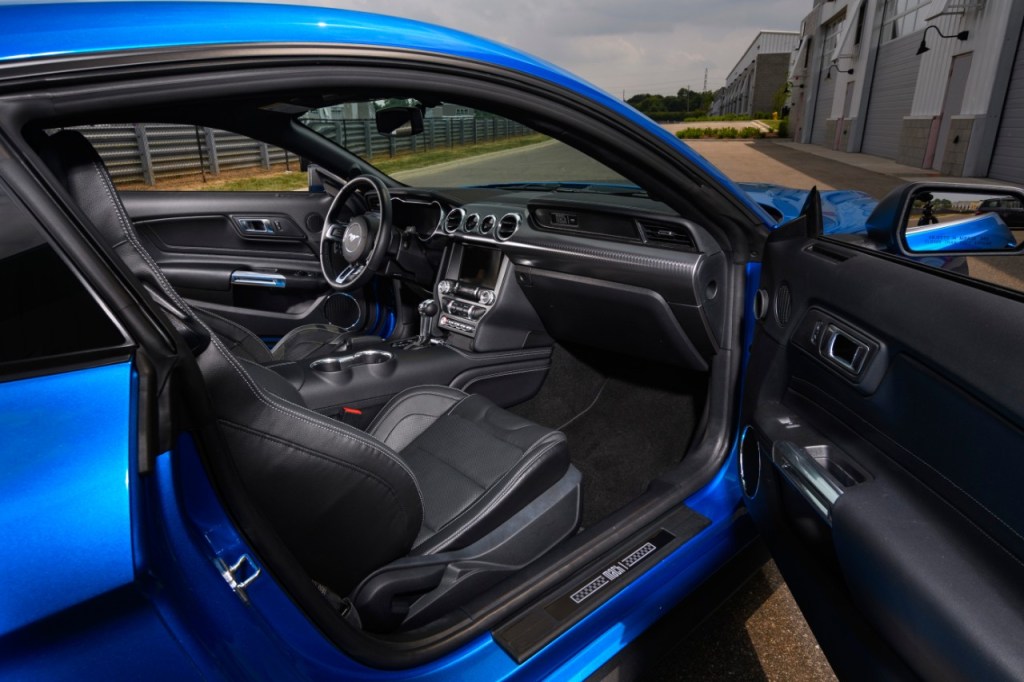 A look into the interior of a blue 2021 Ford Mustang Mach 1 through the view of the passenger door