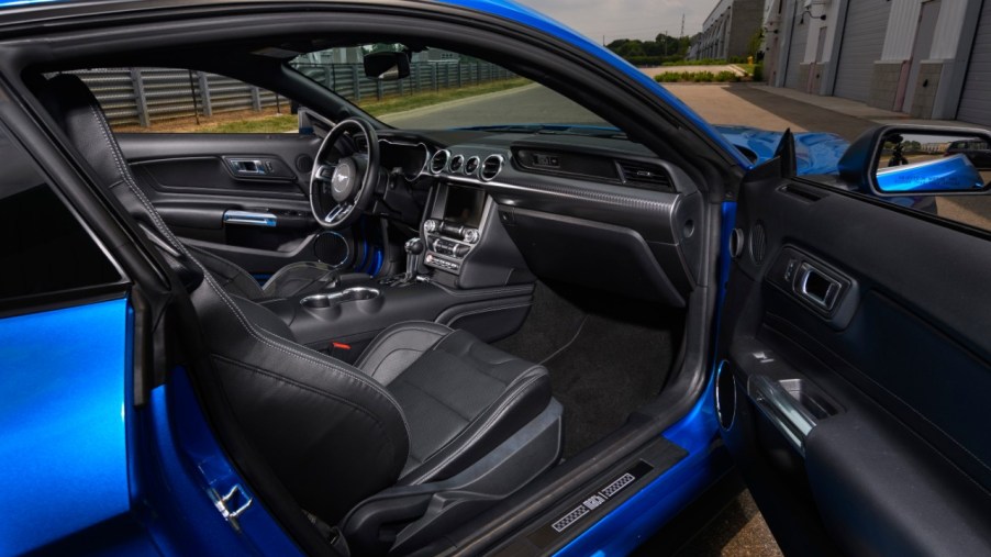 A look into the interior of a blue 2021 Ford Mustang Mach 1 through the view of the passenger door