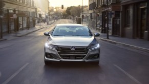 A 2021 Honda Accord Hybrid driving down a city street