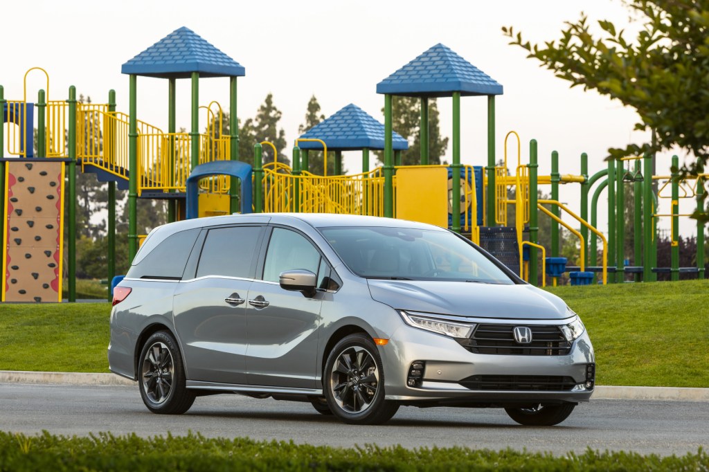 A silver 2021 Honda Odyssey parked in front of a playground